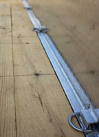 Single axle utility trailer showing welds and hooks.