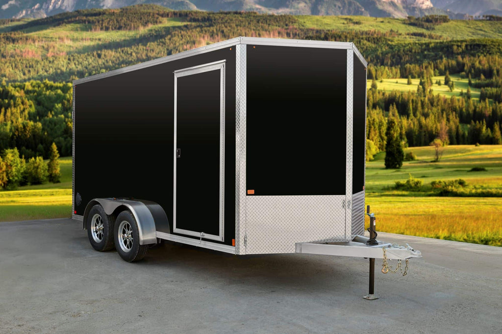 Black tandem-axle enclosed cargo trailer with side access door.