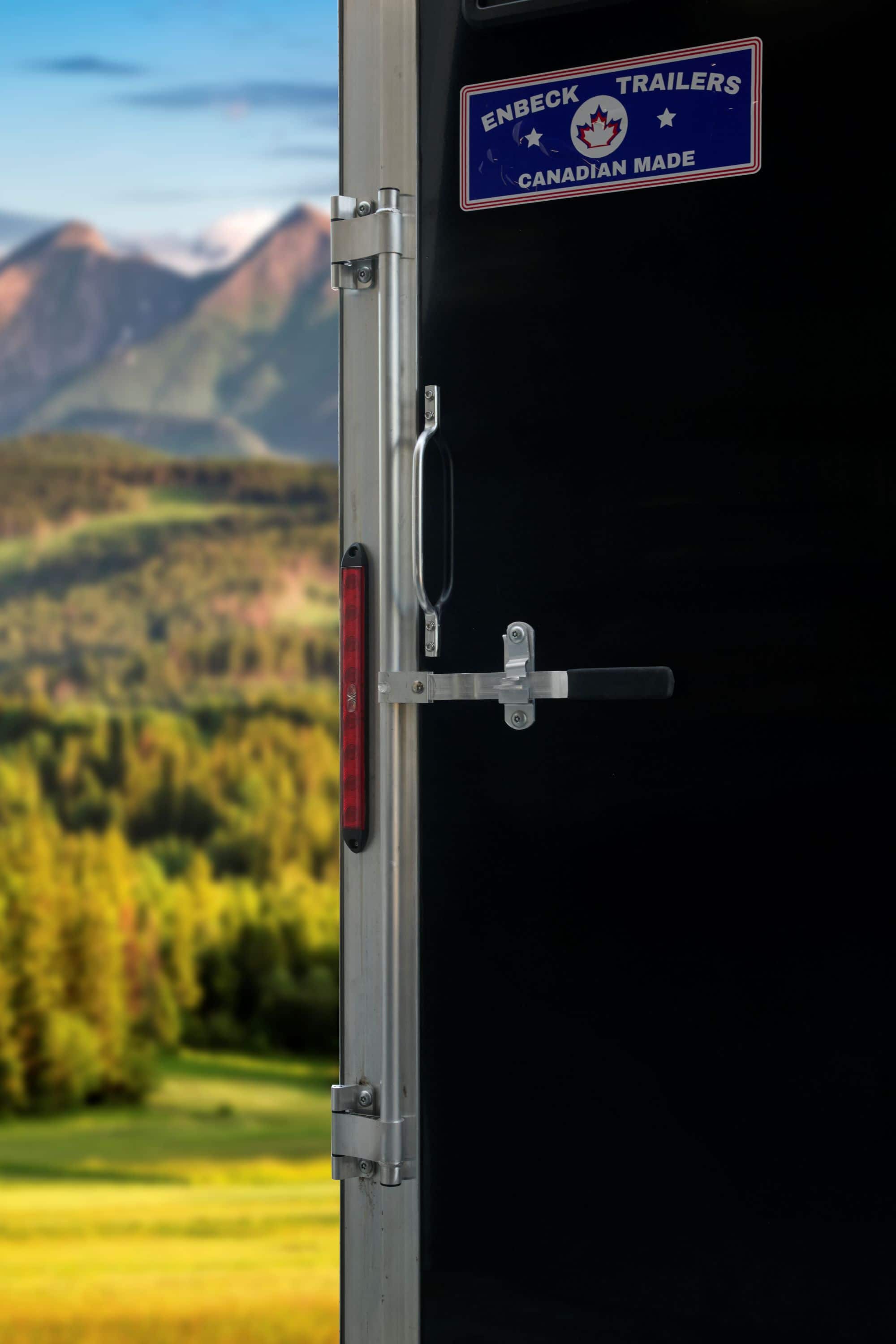 Black tandem-axle cargo trailer close-up detail shot.