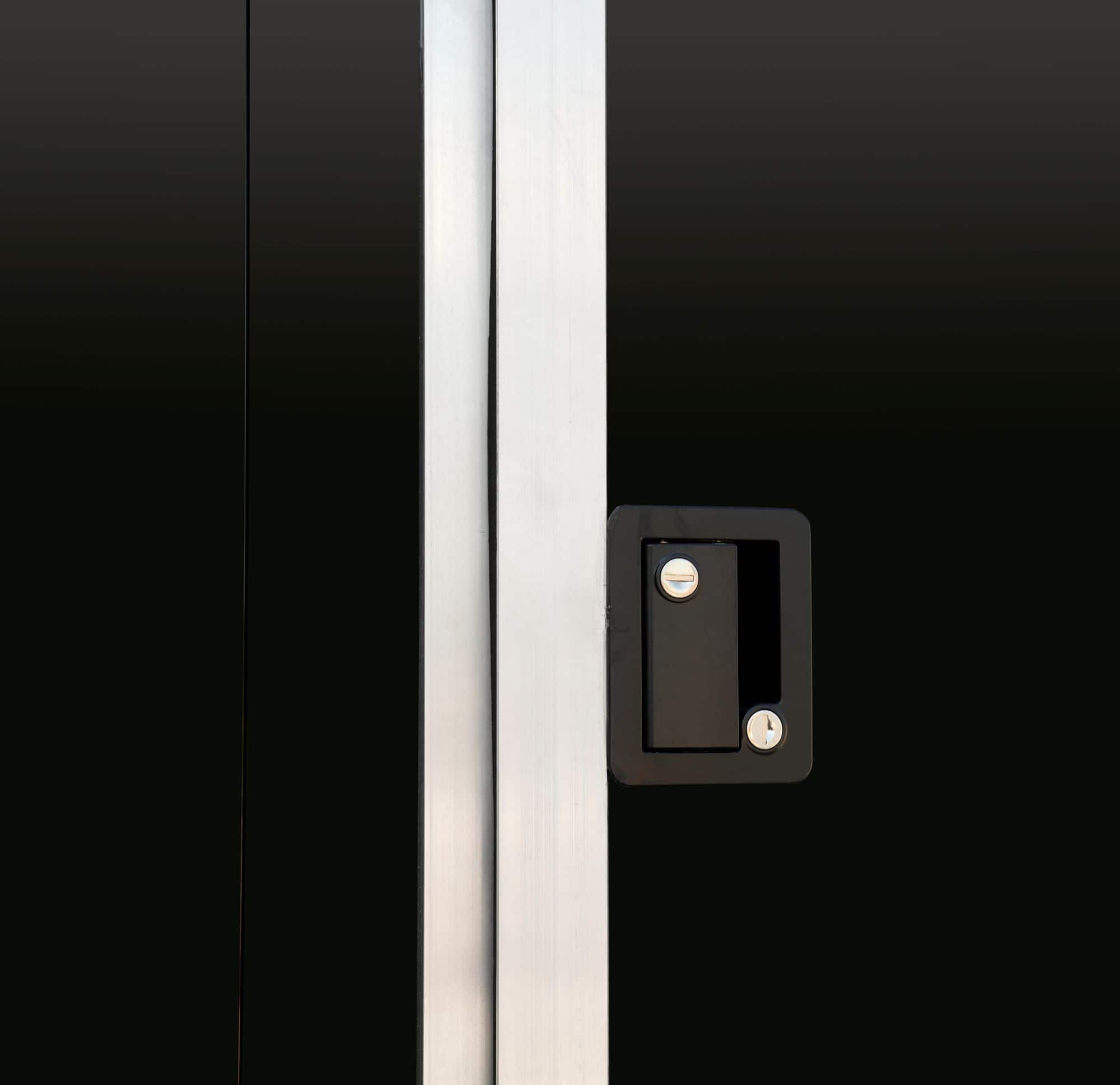 Black tandem-axle enclosed cargo trailer close-up door shot.