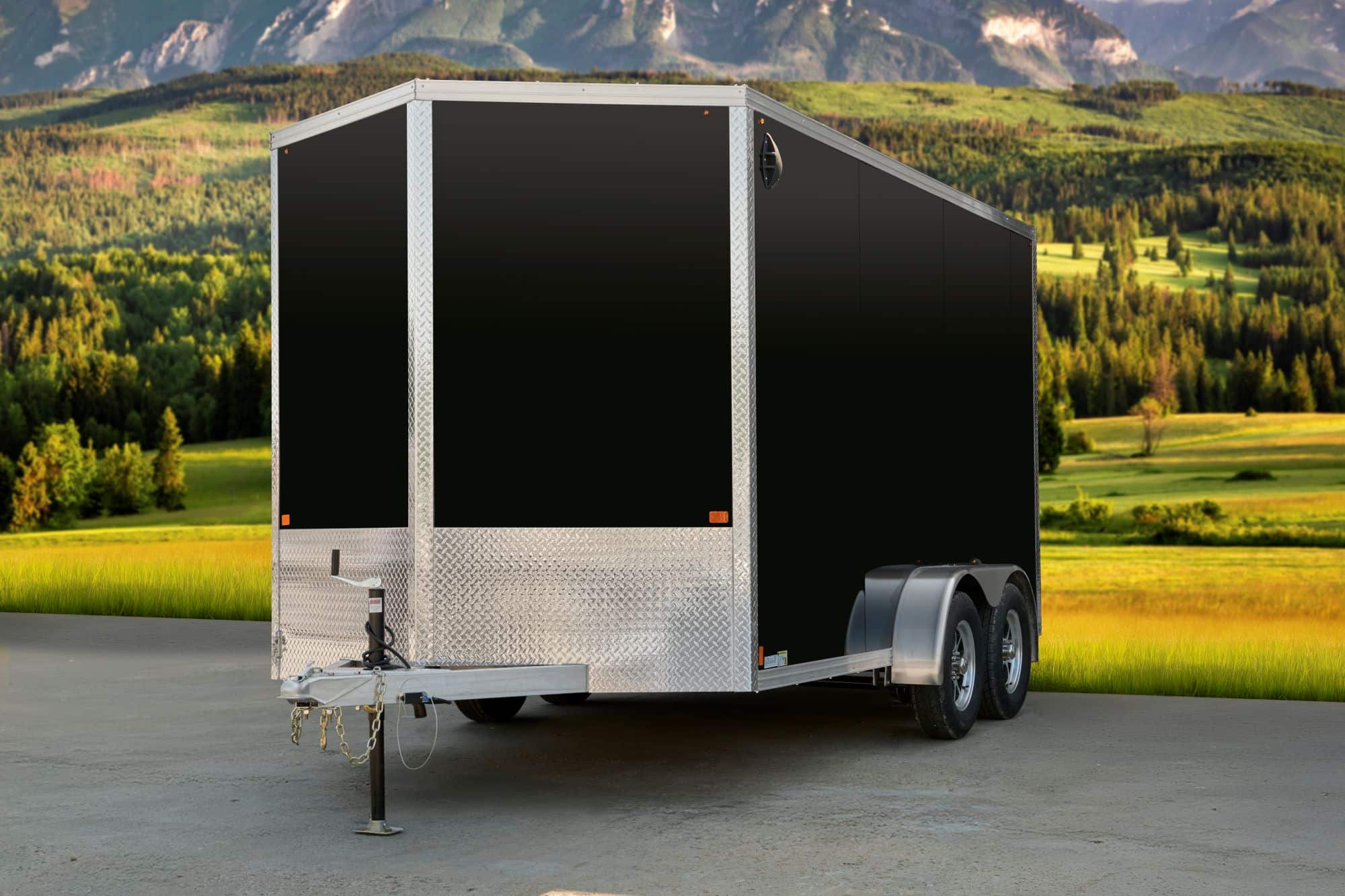 Black tandem-axle enclosed cargo trailer front & side view.