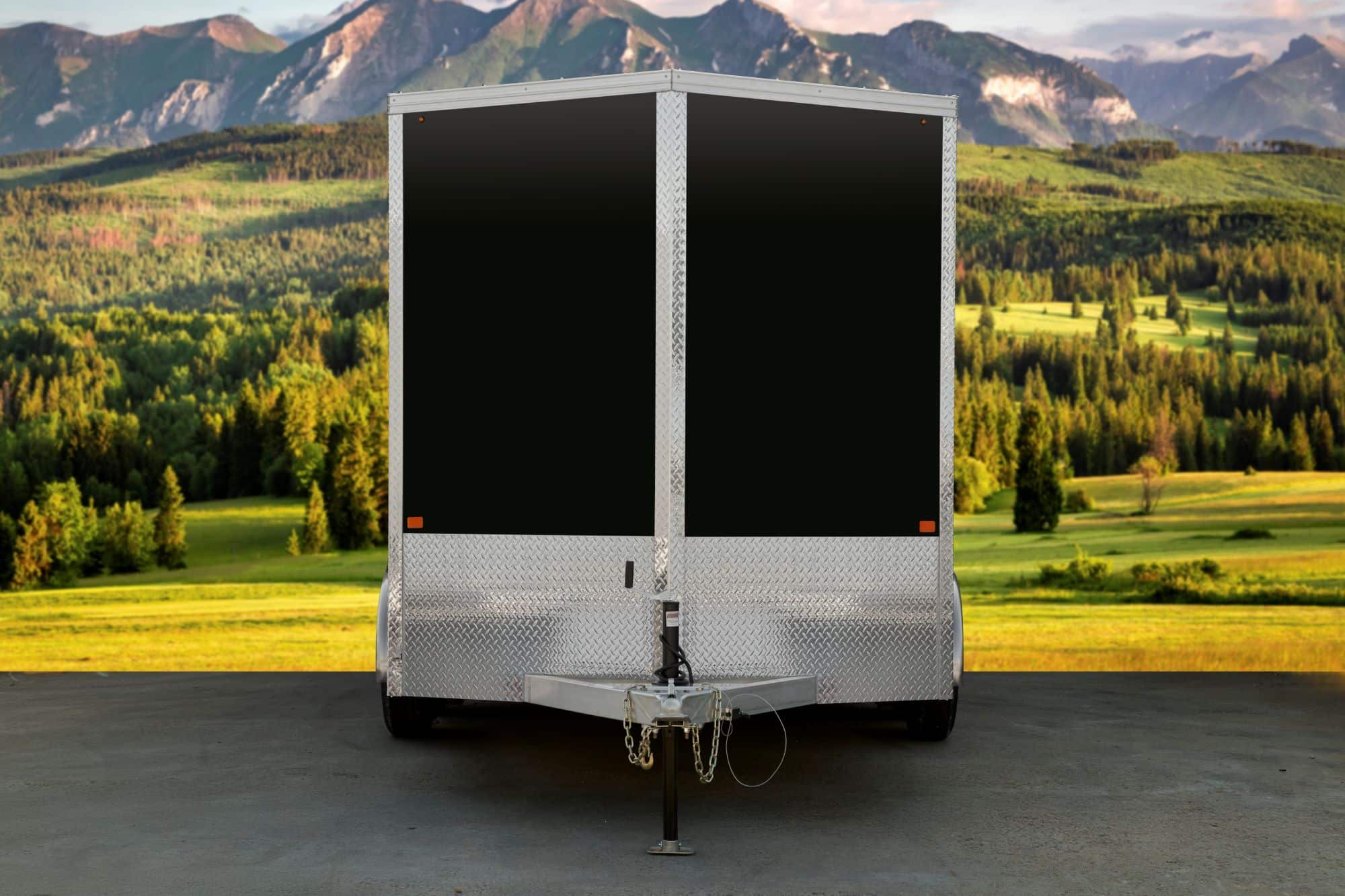 Black tandem-axle enclosed cargo trailer front view.