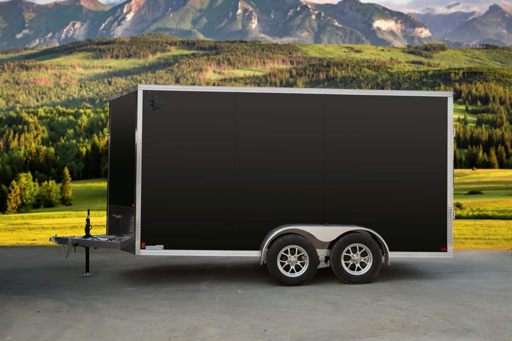 Black tandem-axle enclosed cargo trailer side view. 