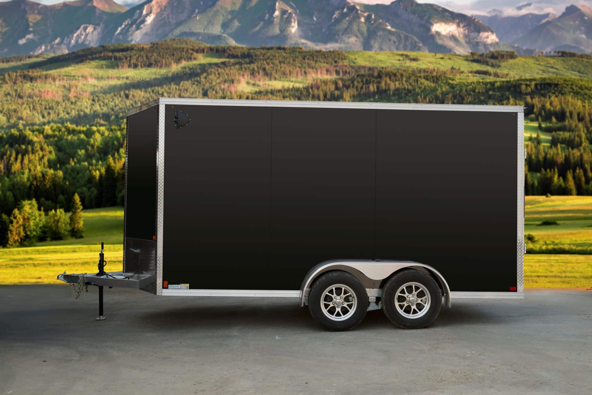 Black tandem-axle enclosed cargo trailer side view. 