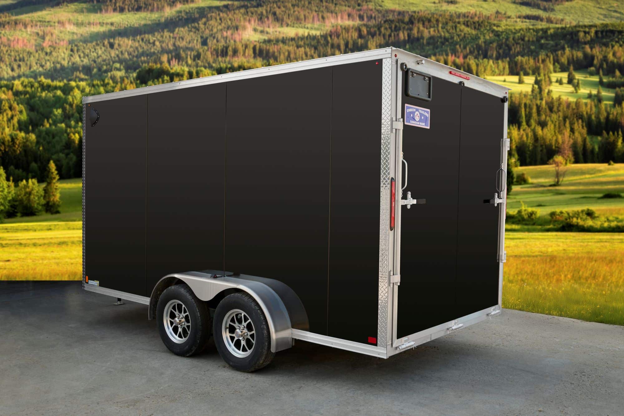 Black tandem-axle enclosed cargo trailer side & back view.
