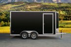Black tandem-axle enclosed cargo trailer side view.