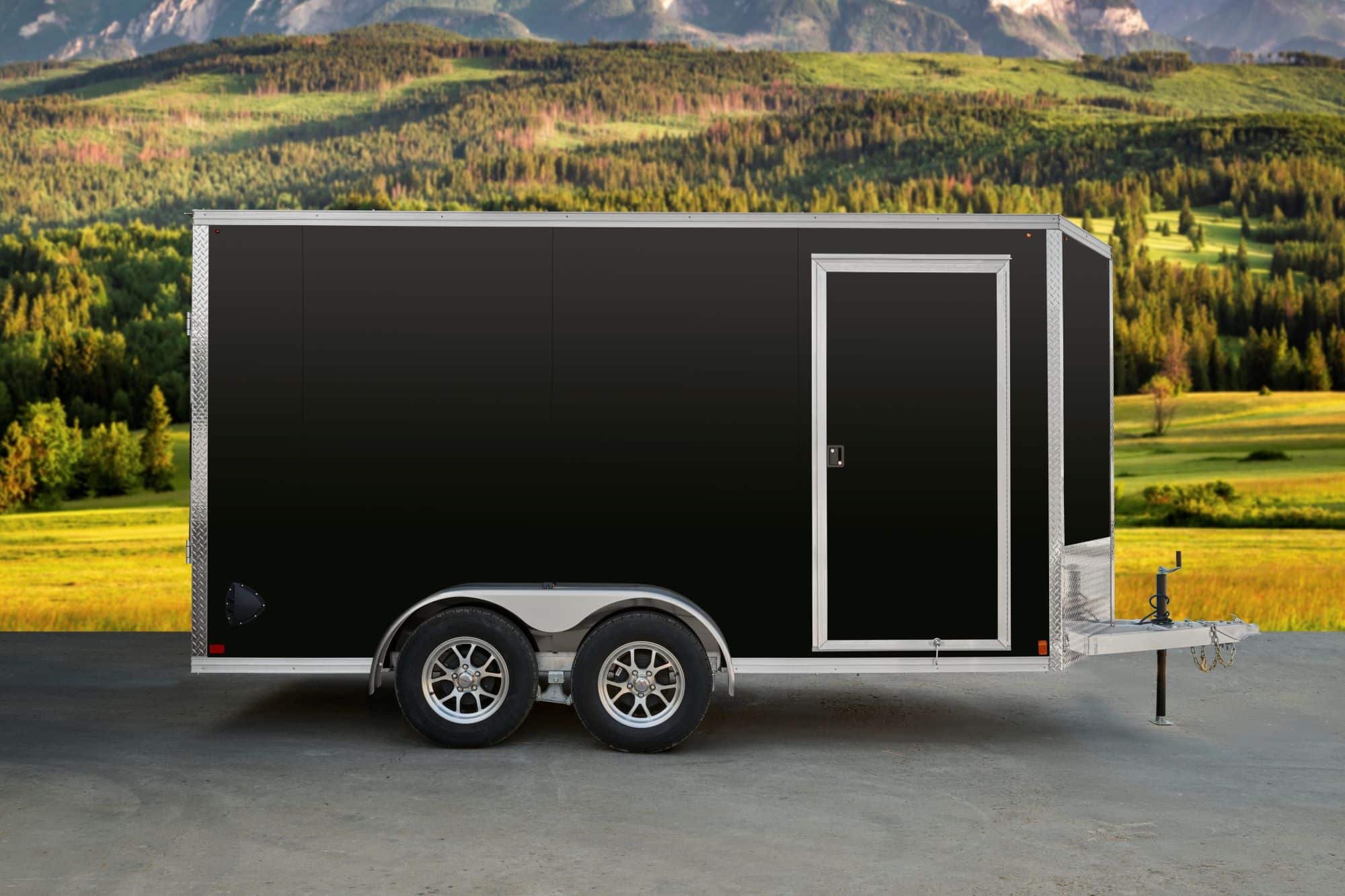 Black tandem-axle enclosed cargo trailer side view.