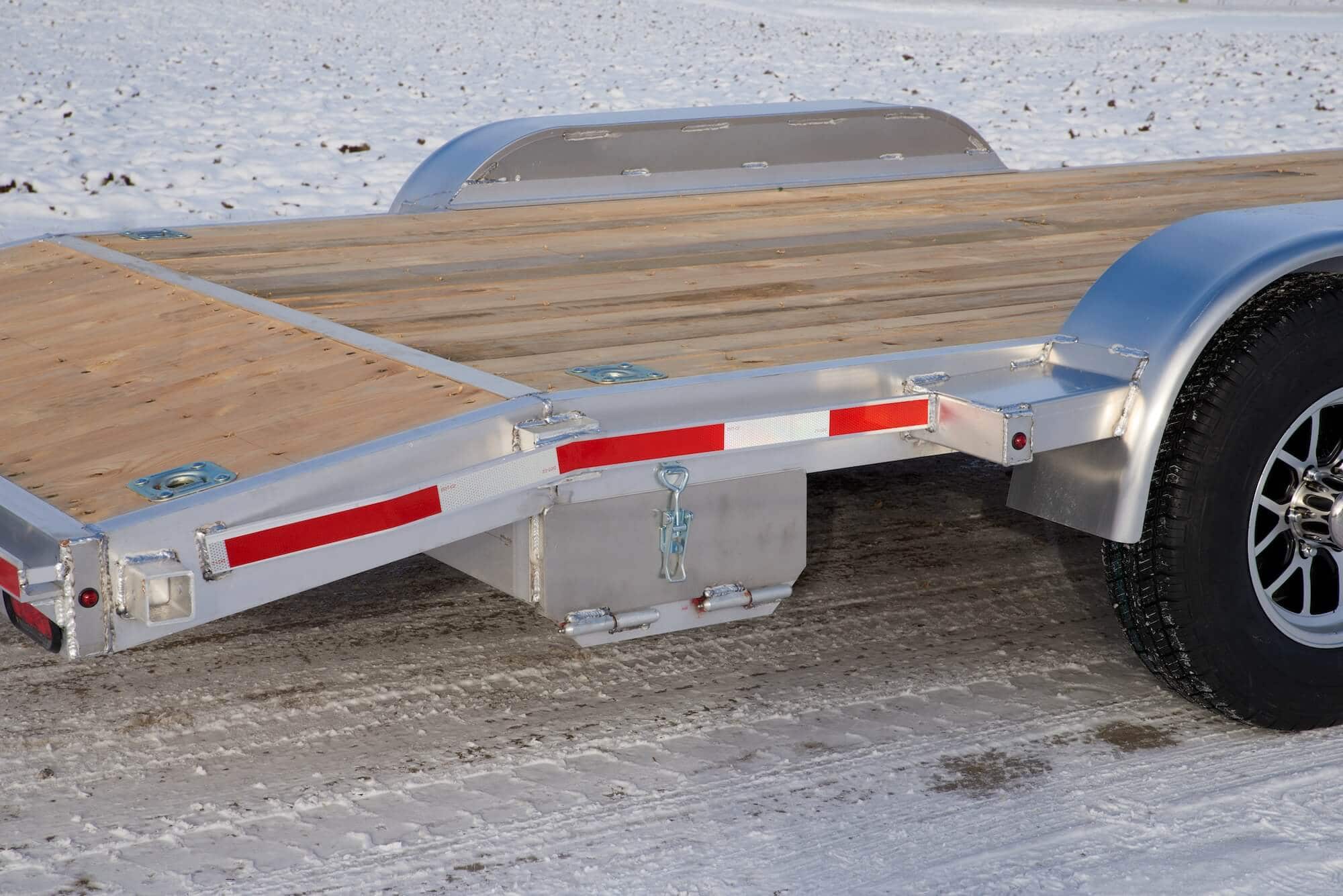 Tandem car hauler with ramp storage compartment closed.